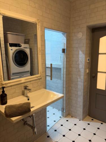 a bathroom with a sink and a microwave at Apartmán No 244 in Tábor