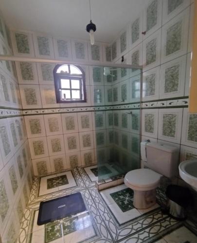 a bathroom with a toilet and a sink at Sitio Serra e Mar in Saquarema
