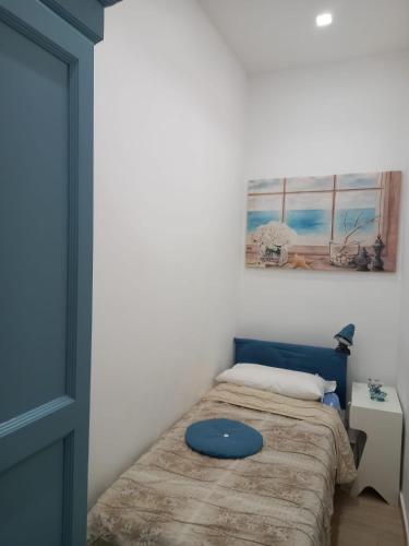 a bedroom with a bed with a blue pillow on it at La casa dei lapilli, Pompei in Terzigno