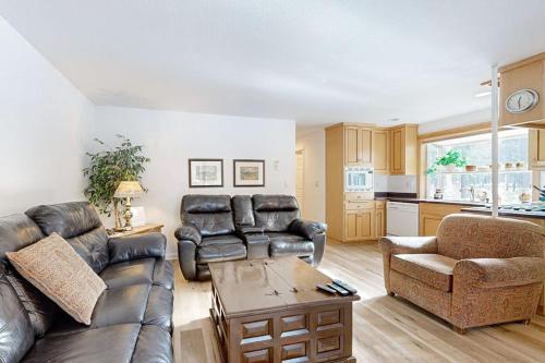 a living room with a couch and a table at Dog-Friendly Sunriver condo with deck bikes in Sunriver