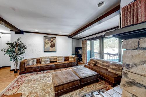 a living room with a couch and a fireplace at Ski getaway with amazing mountain views fireplace pool & river path access in Olympic Valley