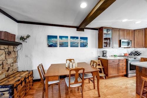 a kitchen and dining room with a table and chairs at Ski getaway with amazing mountain views fireplace pool & river path access in Olympic Valley