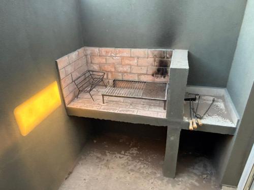 a brick oven in a corner of a room at Añelo Garden Inn in Añelo