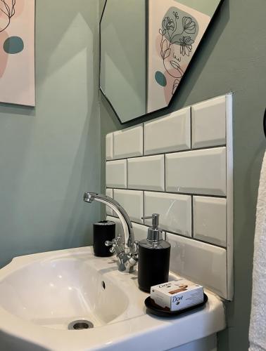 a bathroom sink with a faucet and a mirror at Clifton Home in Richards Bay