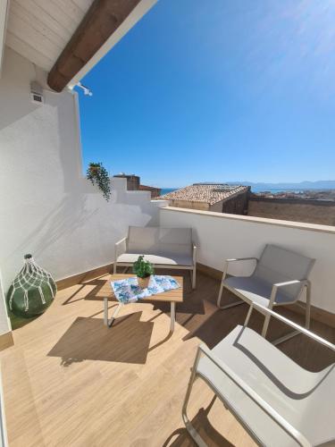 a balcony with chairs and a table and a view at Antò 2.0 in Castellammare del Golfo