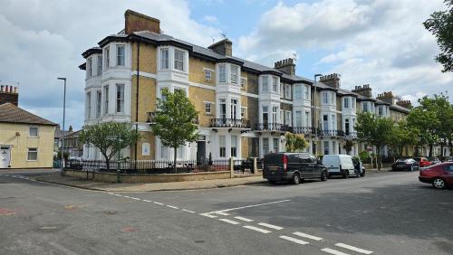 a large building with cars parked in front of it at Seahorse Guesthouse in Great Yarmouth