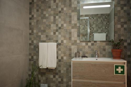 a bathroom with a sink and a mirror at Casas Luar da Aldeia - Apartamentos in Odeceixe