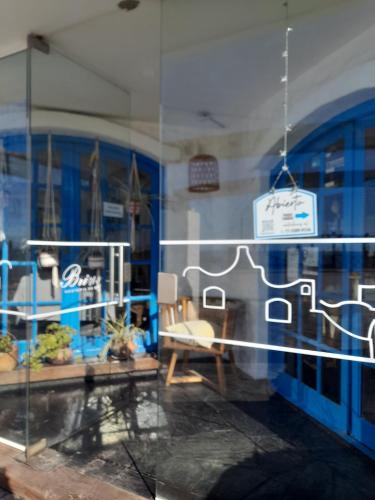a window of a store with a sign on it at Brisas Hosteria in Santa Clara del Mar
