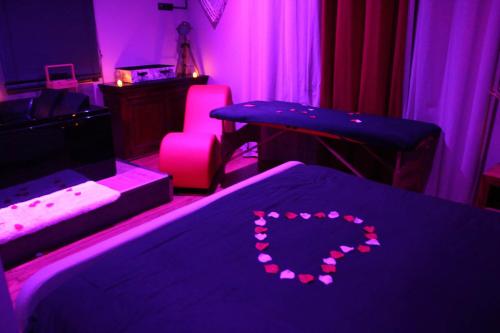 a room with two beds and a heart made out of lights at Secret Balnéo in Floirac