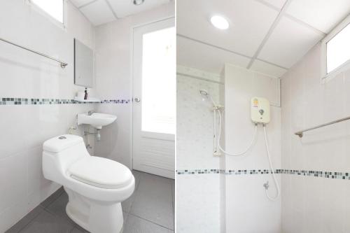 a white bathroom with a toilet and a shower at Dancenter Rq Suvarnabhumi Airport in Bangkok