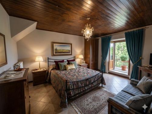 a bedroom with a bed and a couch at Borgo Maggiore in Radicofani