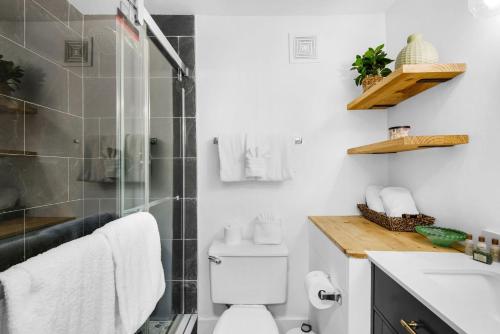 a bathroom with a shower and a toilet and a sink at Renovated Beach Front Condo TOG 310 in Panama City Beach