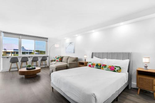 a bedroom with a bed and a couch at Renovated Beach Front Condo TOG 310 in Panama City Beach