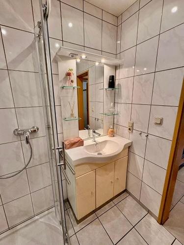 a bathroom with a sink and a shower at Ferienwohnung Theisen in Bernkastel-Kues