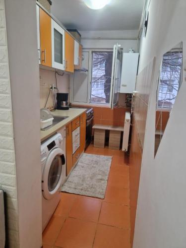 a small kitchen with a washing machine in it at Two-room apartment in Drăgăşani