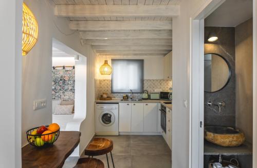a kitchen with a sink and a washing machine at Theasea luxury retreat in Vrachonisída touArchangélou