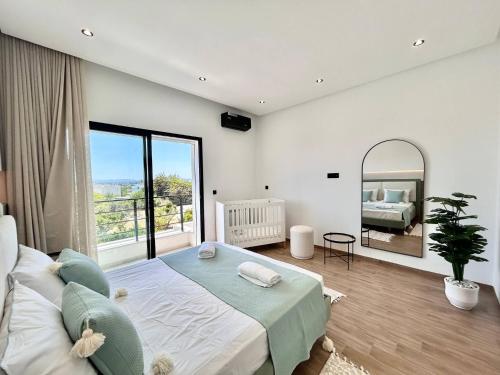 a bedroom with a large bed and a mirror at Villa Ulysse 4 Bedroom Private Pool in Hammamet