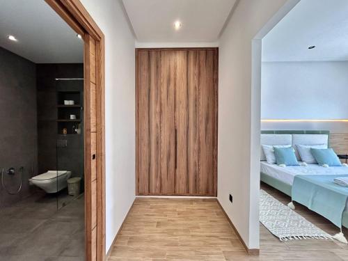 a bedroom with a bed and a bathroom at Villa Ulysse 4 Bedroom Private Pool in Hammamet