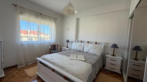 a bedroom with a bed with two night stands and a window at Sunset Hideaway Santa Cruz in Silveira