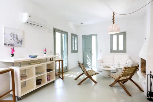 a living room with a couch and a table and chairs at EMELIAS HOUSE SEA SIDE in Naxos Chora