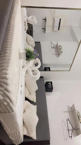 a pile of towels on a shelf in a room at Cozy unit in mivesa garden residence in Cebu City