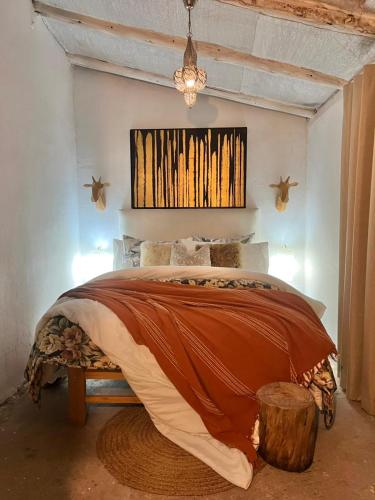 a bedroom with a large bed with a wooden stumpemate sidx sidx sidx at Qenqo's House in Cusco