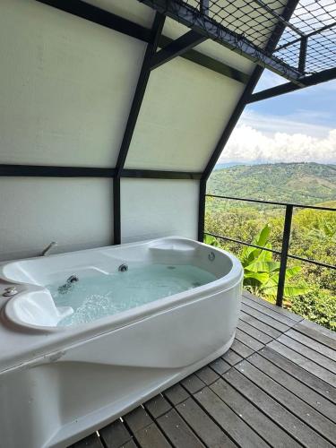 a bath tub sitting on top of a wooden deck at Saray glamping in Palestina