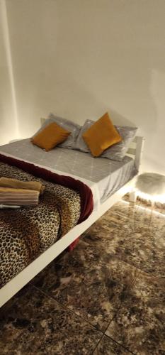 a bed with two pillows on it in a room at Granja Vianna Charming in Cotia