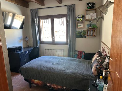 a bedroom with a bed and a window at Can Roura in Rocabruna