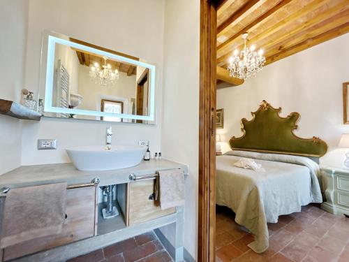 a bathroom with a sink and a bed at Agriturismo La Valle A Polvereto in Tavarnelle Val di Pesa