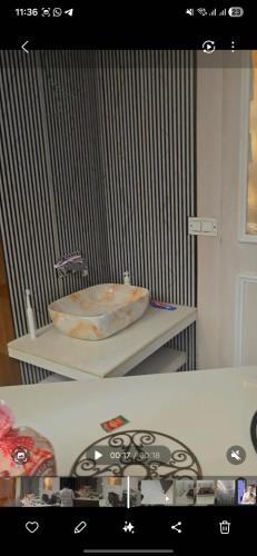 a bathroom with a sink on a table at RYIZ Villa in Agra