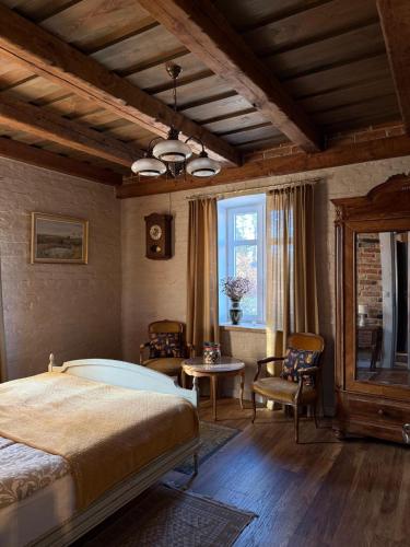 a bedroom with a bed and a table and a window at Akacjowe Wzgórze in Wielęcin