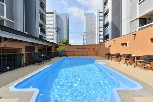 a swimming pool on the roof of a building at O2 Grand Suvarnabhumi Airport - Free Scheduled Shuttle from Hotel to Suvarnabhumi Airport in Bang Phli