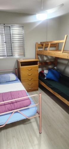 a bedroom with two bunk beds and a dresser at - Apê perto do Alphaville - in Osasco