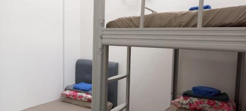 a bedroom with a bunk bed with a ladder to a bunk bed at arin syah homestay in Jasin