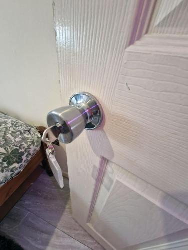 a door knob on a door with a bed at Spacious Double Room - Shared Bathroom - Zone 2 - Smart Lock Entry - No Check In Hassle in London