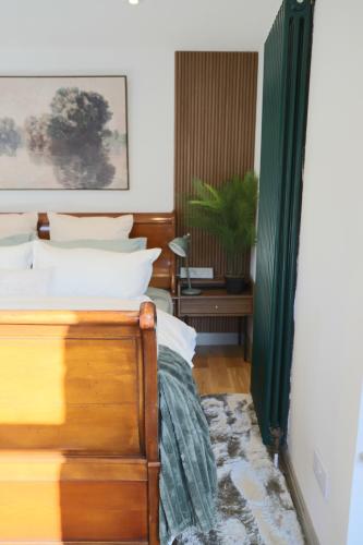 a bedroom with a bed and a green curtain at Stone & Sage- City Centre Luxury Courtyard Lofts in Lancaster