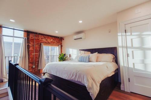 a bedroom with a large bed and a balcony at American Hall - Kaufman Suite in Millersburg