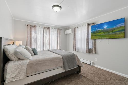 a bedroom with a bed and a large window at Home In Highland Park in Saint Paul