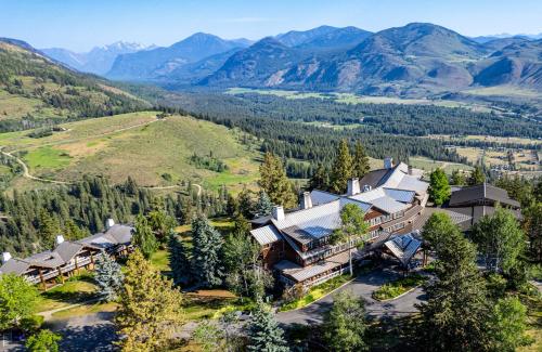 an aerial view of a house on a hill with mountains at Sun Mountain Lodge in Winthrop