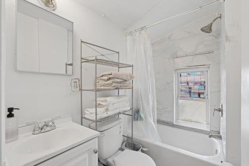 a white bathroom with a toilet and a sink at Home In Highland Park in Saint Paul