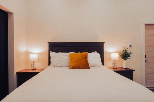 a bedroom with a large white bed with two lamps at American Hall - Hamilton Suite in Millersburg