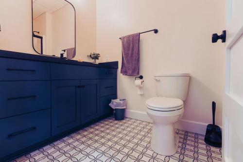 a bathroom with a toilet and a sink and a mirror at American Hall - Hamilton Suite in Millersburg