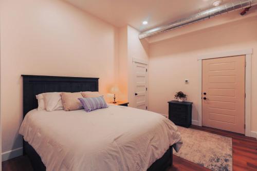 a bedroom with a large bed and a closet at American Hall - Young Suite in Millersburg