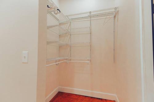 a walk in closet with white walls and shelves at American Hall - Young Suite in Millersburg