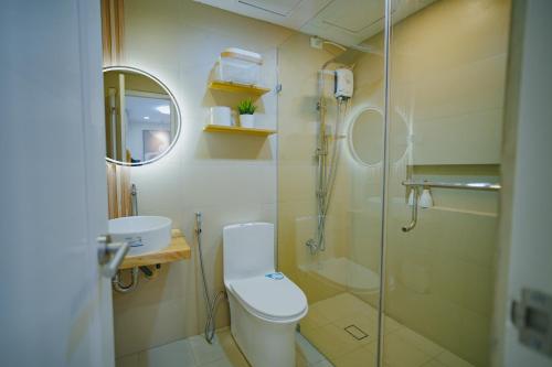 a bathroom with a toilet and a glass shower at Silid Pahingahan at Forest Residences in Antipolo
