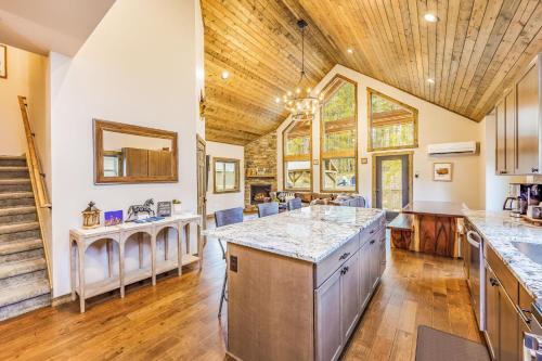 an open kitchen with a large island and wooden ceilings at Norwester Stay in Ronald