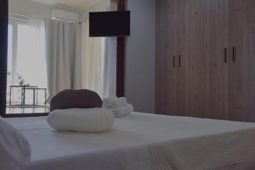 a stuffed teddy bear sitting on top of a bed at thalore room e apartments in Amantea