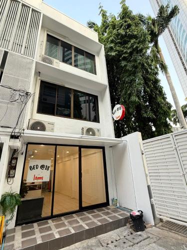 a white building with a large window on it at BED at 18 Asoke in Bangkok