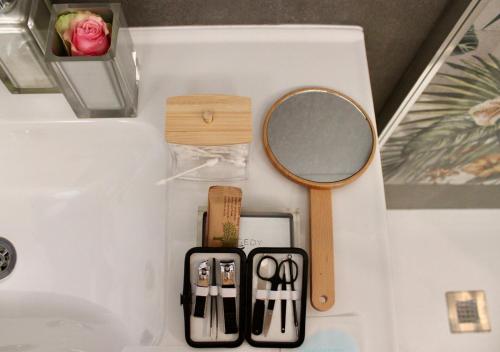 a mirror and other items on a bathroom counter at Casa Flavia-Comfort e relax nel cuore di Ariccia in Ariccia